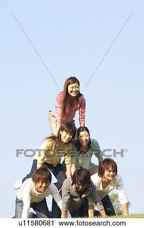 Friends making a human pyramid View Large Photo Image Stock Image - Friends making a human pyramid. Fotosearch
