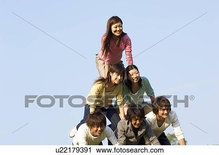 Friends making a human pyramid View Large Photo Image Stock Image - Friends making a human pyramid. Fotosearch