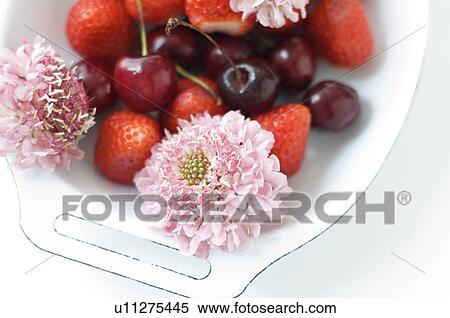Stock Photography - Fruit served in a tray with flowers. Fotosearch