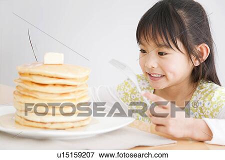 Girl about to enjoy a stack of pancakes View Large Photo Image Stock Photo - Girl about to enjoy a stack of pancakes. Fotosearch