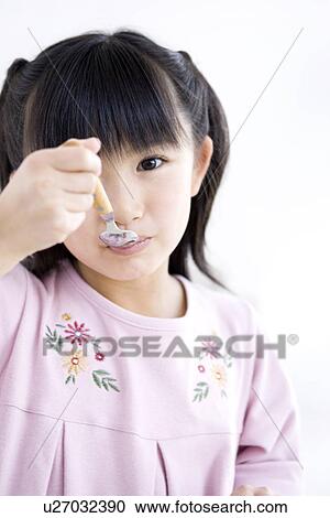 Girl eating a meal View Large Photo Image Stock Image - Girl eating a meal. Fotosearch