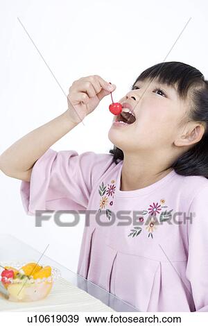 Stock Photo - Girl eating fruit salad. Fotosearch