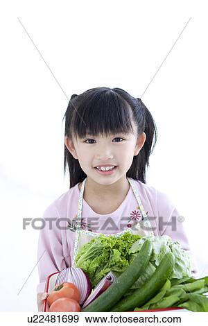 Girl holding vegetables View Large Photo Image Stock Photo - Girl holding vegetables. Fotosearch