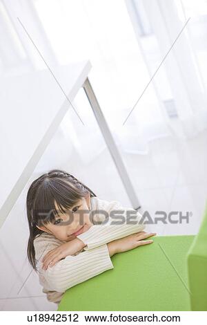Girl leaning on a chair View Large Photo Image Stock Image - Girl leaning on a chair. Fotosearch