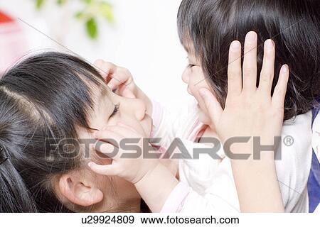 Girl playing with her baby sister View Large Photo Image Stock Photo - Girl playing with her baby sister. Fotosearch