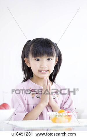 Girl saying grace before a meal View Large Photo Image Stock Image - Girl saying grace before a meal. Fotosearch