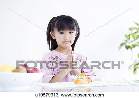 Girl saying grace before a meal View Large Photo Image Stock Image - Girl saying grace before a meal. Fotosearch