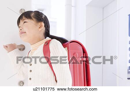 Girl standing in a doorway View Large Photo Image Stock Photography - Girl standing in a doorway. Fotosearch