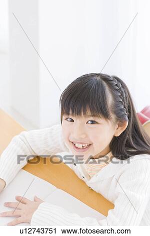 Stock Image - Girl studying. Fotosearch