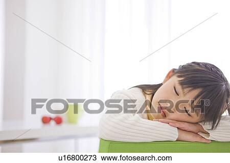 Stock Image - Girl taking a nap. Fotosearch