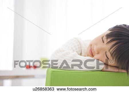Stock Image - Girl taking a nap. Fotosearch