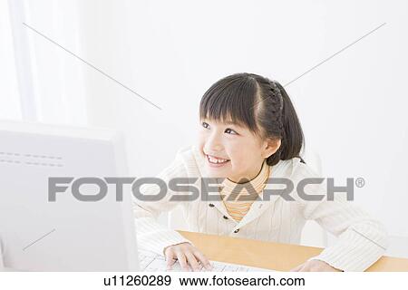 Stock Photo - Girl using a computer. Fotosearch