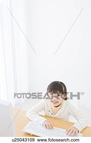 Girl using a computer View Large Photo Image Stock Photo - Girl using a computer. Fotosearch