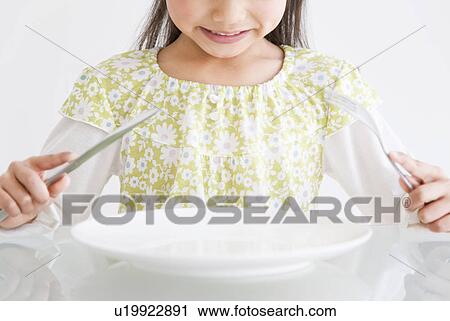 Stock Image - Girl waiting for her food. Fotosearch