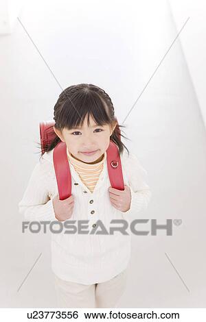 Stock Photograph - Girl wearing a backpack. Fotosearch