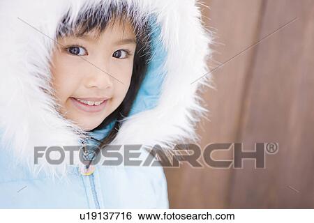 Girl wearing a hooded jacket View Large Photo Image Stock Photograph - Girl wearing a hooded jacket. Fotosearch