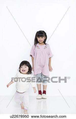 Girl with her baby sister View Large Photo Image Stock Image - Girl with her baby sister. Fotosearch