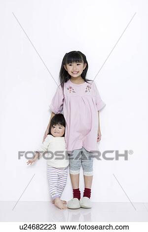 Girl with her baby sister View Large Photo Image Stock Image - Girl with her baby sister. Fotosearch
