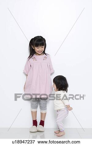 Girl with her baby sister View Large Photo Image Stock Photo - Girl with her baby sister. Fotosearch