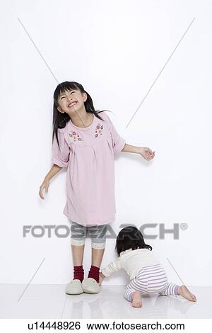 Girl with her baby sister View Large Photo Image Stock Photograph - Girl with her baby sister. Fotosearch