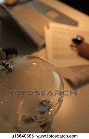 Stock Photography - Glass globe on desk in office. Fotosearch