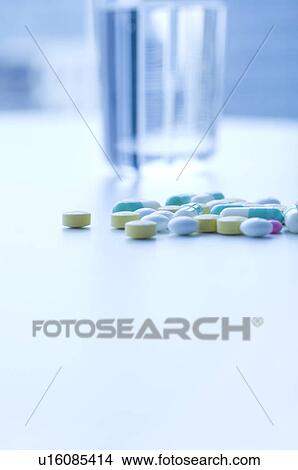 Picture - Glass of water and pills. Fotosearch