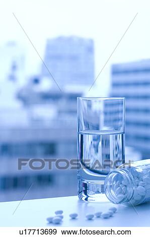 Stock Photo - Glass of water and pills. Fotosearch