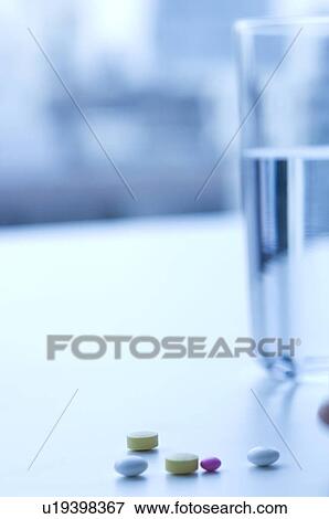 Stock Photo - Glass of water and pills. Fotosearch