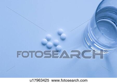 Stock Photography - Glass of water and pills. Fotosearch