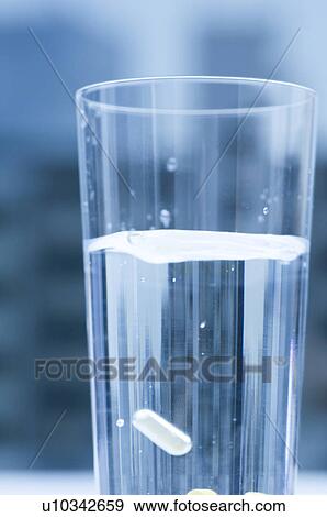 Glass of water with a pill View Large Photo Image Stock Photo - Glass of water with a pill. Fotosearch
