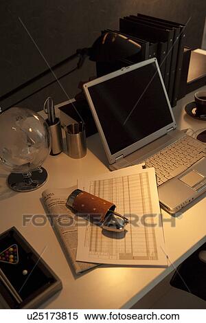 Stock Photography - Glasses, documents and laptop on desk. Fotosearch