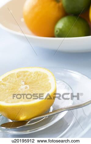 Stock Image - Grapefruit slice on table setting. Fotosearch