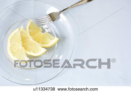 Stock Photo - Grapefruit slice on table setting. Fotosearch