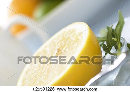 Stock Photograph - Grapefruit slice on table setting. Fotosearch