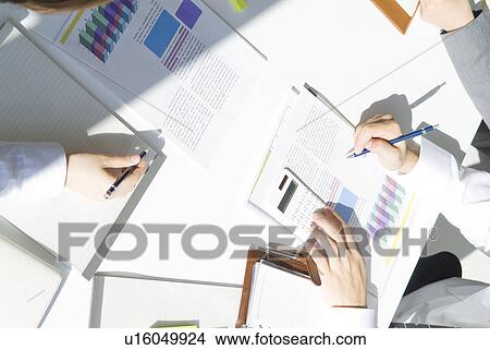 Picture - Hands of office workers planning in a meeting. Fotosearch