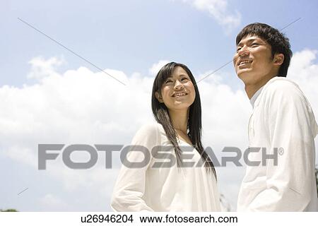 Happy couple under a blue sky View Large Photo Image Picture - Happy couple under a blue sky. Fotosearch