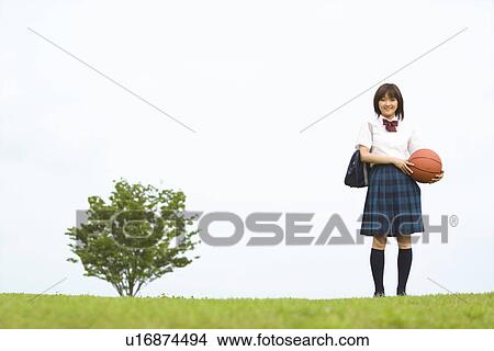 Picture - High school girl holding basketball. Fotosearch