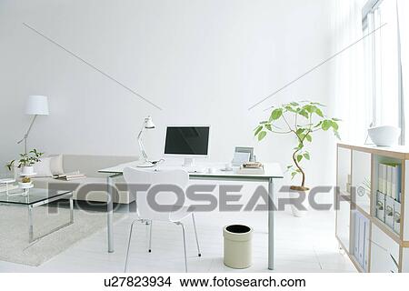 Home office in living room with potted plant View Large Photo Image Picture - Home office in living room with potted plant. Fotosearch
