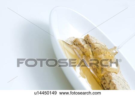 Honey being poured onto crackers View Large Photo Image Stock Photo - Honey being poured onto crackers. Fotosearch
