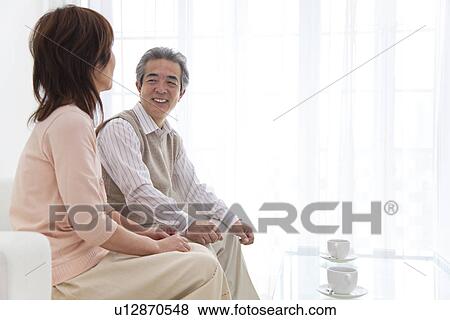 Stock Photo - Husband and wife having coffee together. Fotosearch