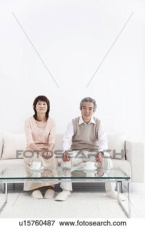 Stock Photo - Husband and wife having coffee together. Fotosearch