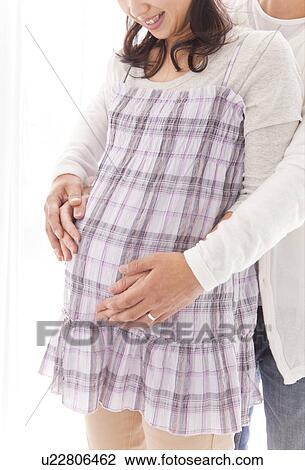 Husband standing behind pregnant wife, touching her belly View Large Photo Image Stock Image - Husband standing behind pregnant wife, touching her belly. Fotosearch