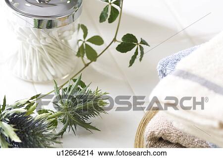 Jar of cotton swabs and folded towels View Large Photo Image Picture - Jar of cotton swabs and folded towels. Fotosearch