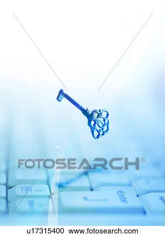 Stock Image - Key hovering over computer keyboard. Fotosearch