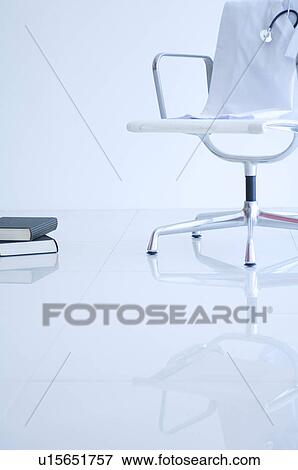 Stock Photo - Lab coat and stethoscope draped over a chair. Fotosearch