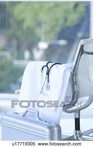 Stock Photography - Lab coat and stethoscope draped over a chair. Fotosearch
