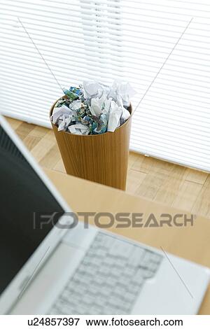 Laptop computer on desk near wastepaper bin View Large Photo Image Stock Photo - Laptop computer on desk near wastepaper bin. Fotosearch