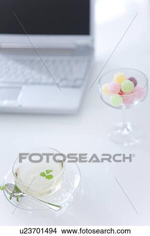 Laptop, herbal tea and a glass of candy View Large Photo Image Picture - Laptop, herbal tea and a glass of candy. Fotosearch
