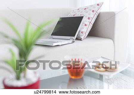 Laptop on a sofa and afternoon tea View Large Photo Image Picture - Laptop on a sofa and afternoon tea. Fotosearch