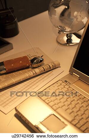 Laptop on desk in office View Large Photo Image Stock Photograph - Laptop on desk in office. Fotosearch